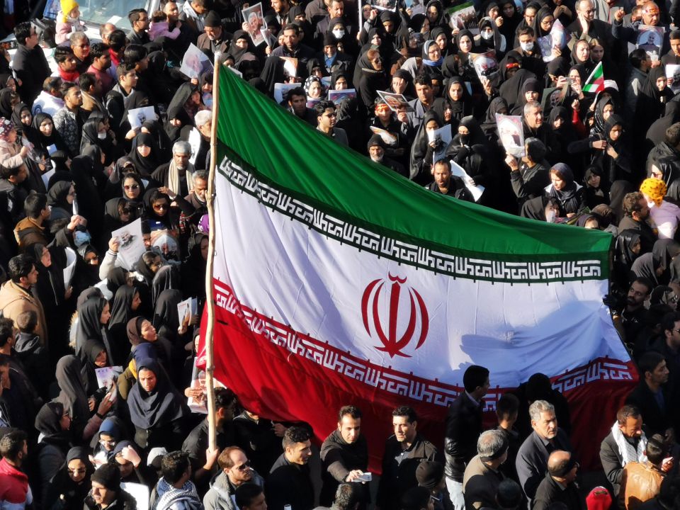  Mourners wave a huge Iranian flag during Soleimani's funeral