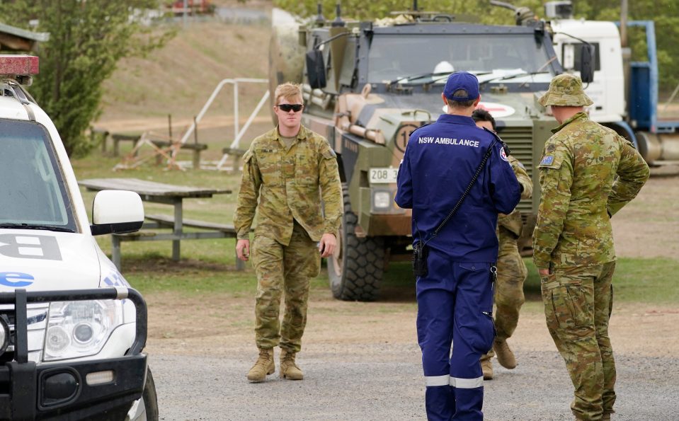 Australian Army personnel and Ambulance officer gather at Numeralla near the scene