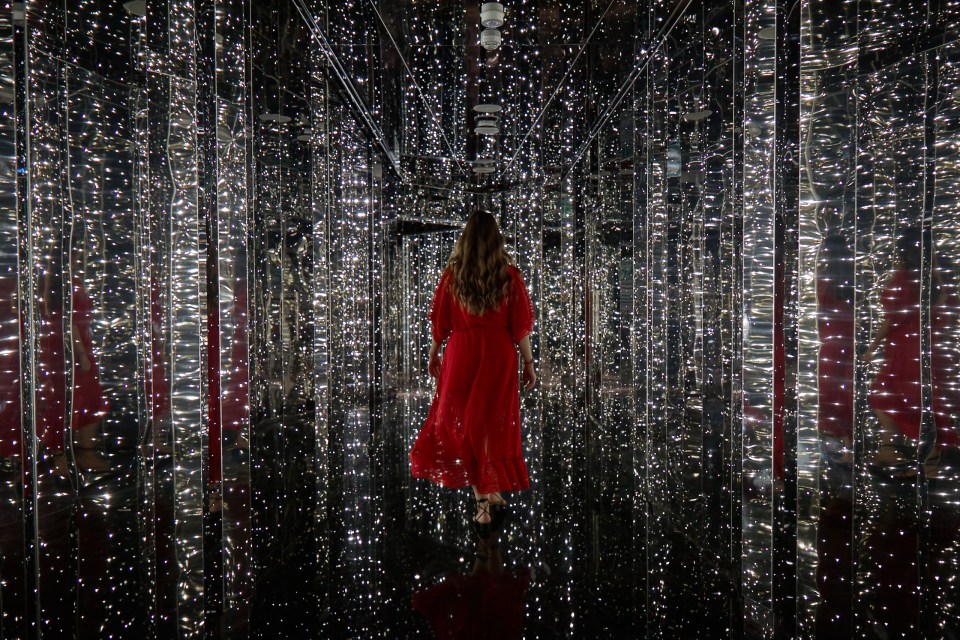 Passengers enter the nightclub through a dramatic hall of mirrors