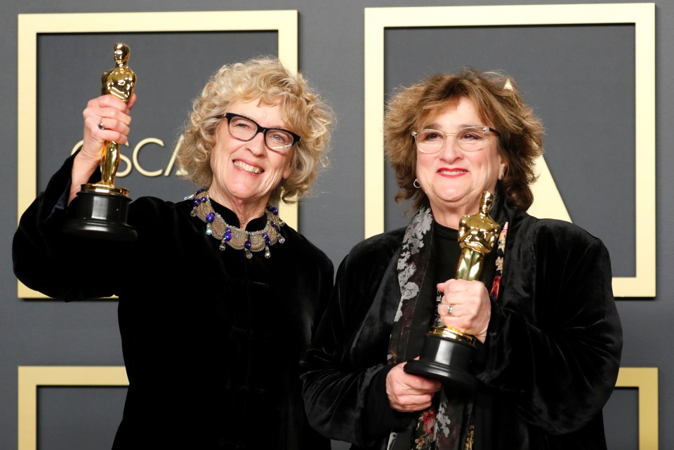 Barbara Ling, left, and Nancy Haigh, right, pick up the gong for Best Production Design
