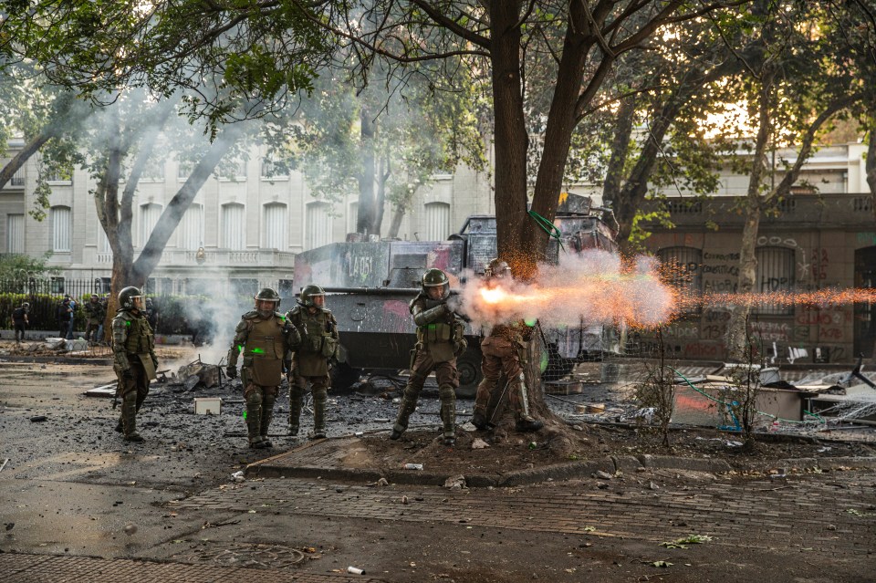Riot cops fire teargas at protesters on the streets of Chile