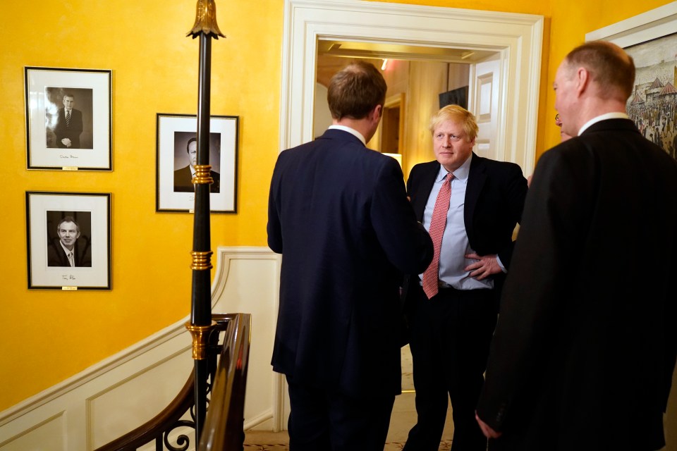 Mr Johnson, Mr Hancock and Prof Whitty speaking to each other at the stairs of Downing Street after a coronavirus press conference on March 12