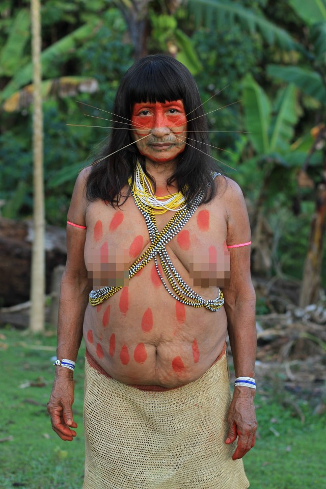 This Matses woman is covered in the symbolic red paint