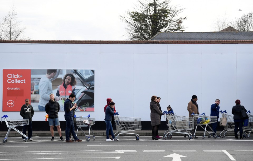  Shoppers queue to enter a supermarket as they observe social distancing rules