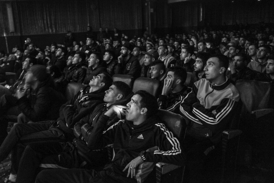 Football fans watch the action on big screens in Algiers