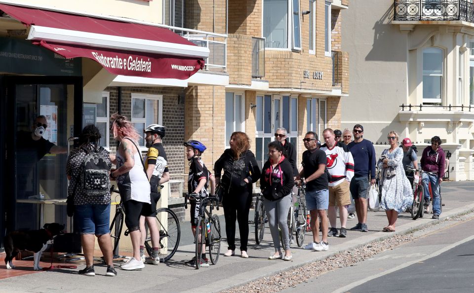  People queue for ice cream from a cafe in Hove, East Sussex and disobey the reccomended two metre distancing rule