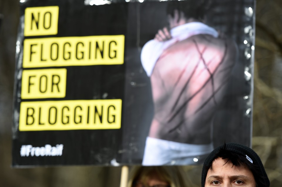 Amnesty International activists protest with a placard reading 'No flogging for blogging' against the flogging punishment of Saudi blogger Raif Badawi 