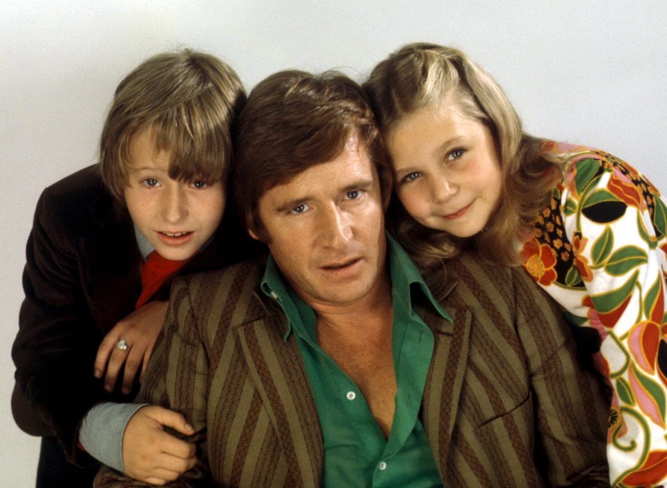Linus Roache (left) with real life and on-screen dad Bill Roache and Susan Barlow actress Wendy Jane Walker in 1974