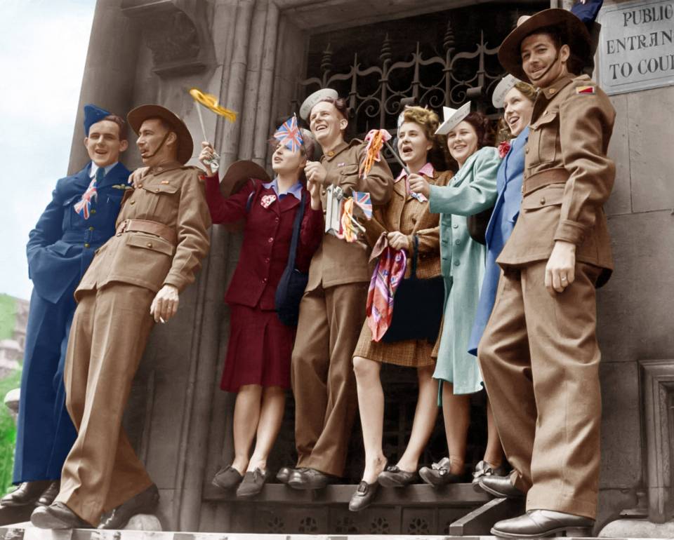 A group of friends watch the celebrations wearing hats that say "It's lurve I want" and "Will I do?"