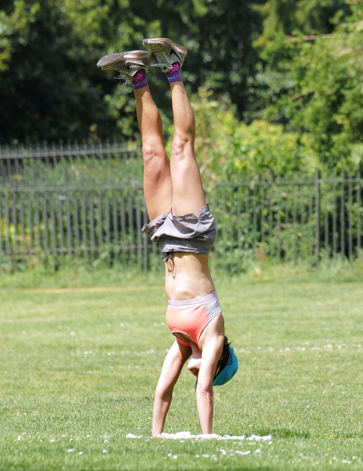  A woman shows off a handstand in Hyde Park over the weekend
