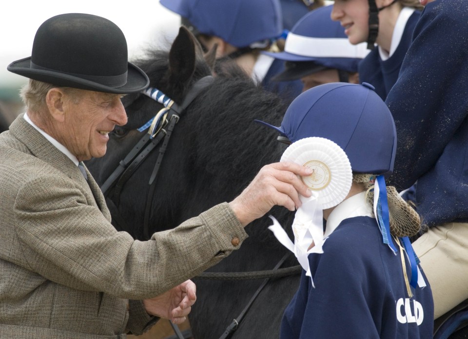 Prince Philip distributes awards at Windsor Horse Show in May 2013