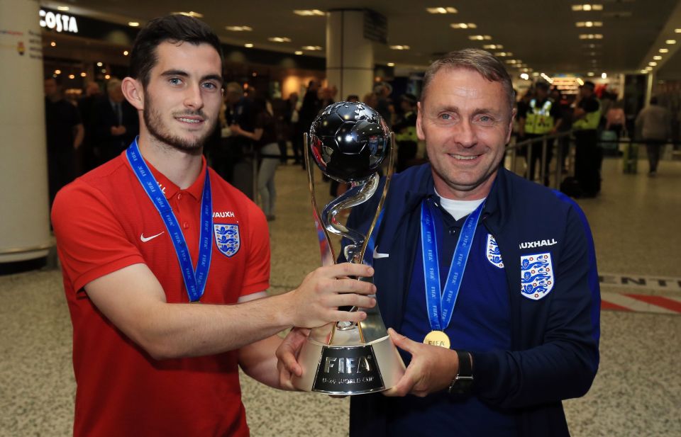  Captain Lewis Cook poses with the trophy along with manager Paul Simpson