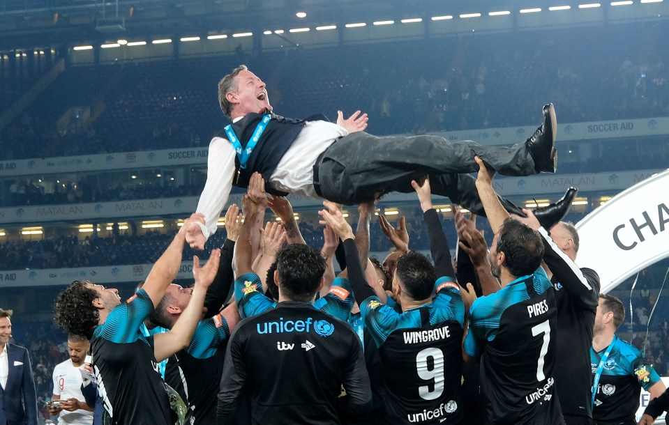 World XI's assistant manager Piers Morgan is thrown by the team after winning last year's  Soccer Aid match