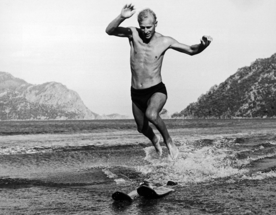 Prince Philip jumps off water skis as he approaches the beach at Marmarice in Turkey, August 5, 1951