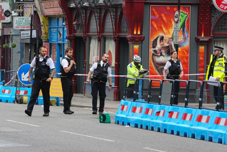 Police at the scene after Rabbi Alter Yaakov Schlesinger, in his 50s, was knifed in broad daylight