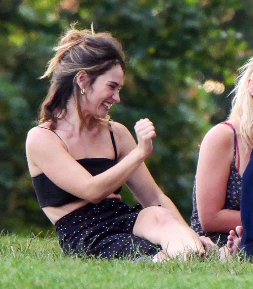 Meanwhile Lily can be seen with her hair scraped back and in a black vest-top in our pictures