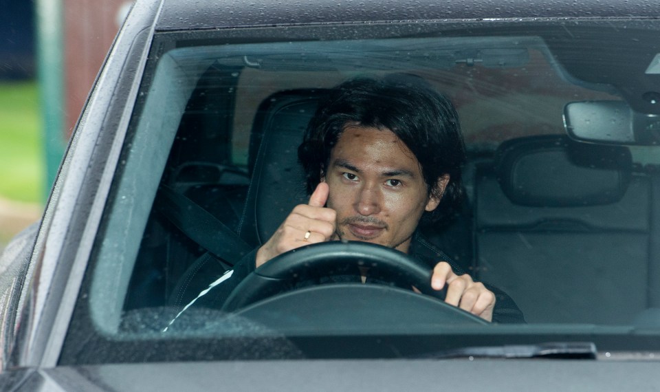 Reds new boy Takumi Minamino gives a thumbs up to the cameras 