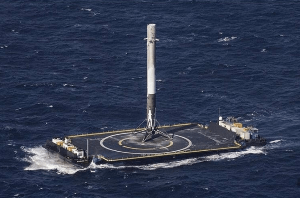 A Falcon 9 booster sits on the Of Course I Still Love You drone ship following a successful landing