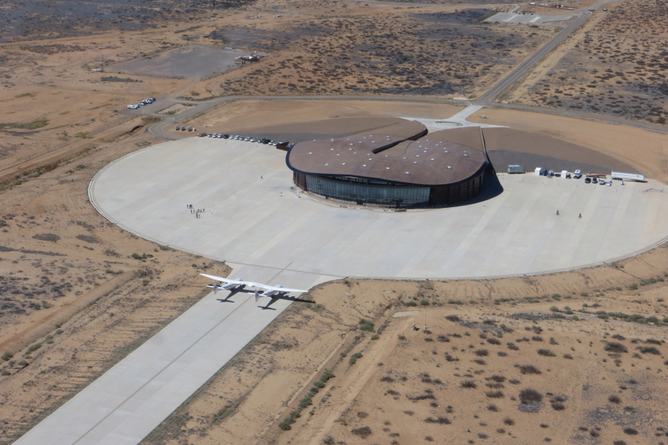 Spaceport America, Virgin Galactic's commercial spaceport, with Carrier Aircraft, VMS Eve on Tarmac. VMS Eve will be used to carry a smaller plane, dubbed SpaceShipTwo, up to a certain height before it releases its payload. SpaceShipTwo then heads to orbit