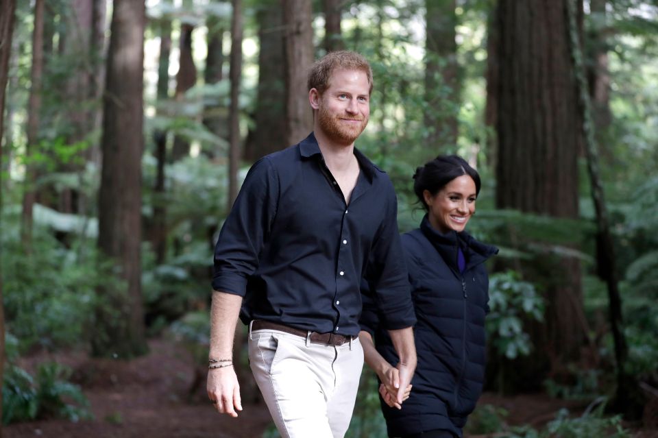 Prince Harry and Meghan Markle are all smiles during a visit to Redwoods Tree Walk and Mountain Biking Showcase in Rotorua, New Zealand