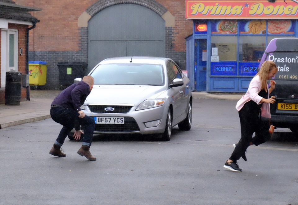Gary pushes Sarah out of the way of an oncoming car