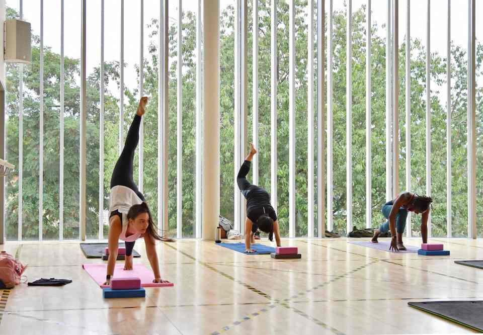 People take part in a socially distanced yoga class at Kensington Leisure Centre in west London