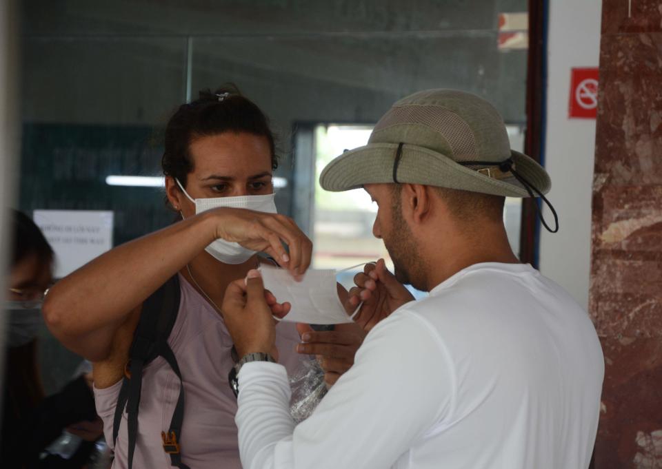 Foreign tourists wearing face masks in the railway station in Danang 