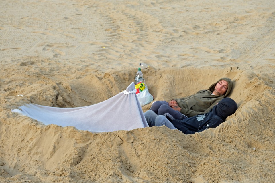 Visitors to Bournemouth dug themselves into the sand to sleep so they could get the best spots on Saturday