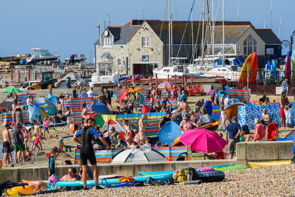 The beach at Lyme Regis in Dorset was already filling up early on Saturday morning