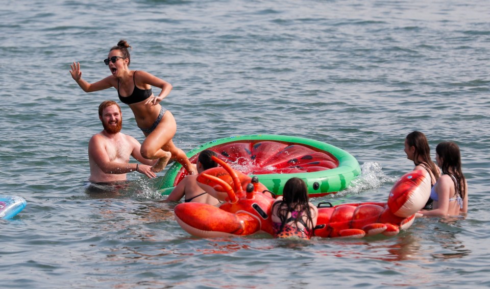 A family played in the sea off the coast of Swanage in Dorset