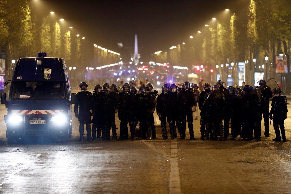 Riot police block the Champs Elysees