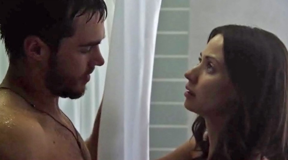 Containment characters Katie Frank (Kristen Gutoskie) and Jake Riley (Chris Wood) share an intimate moment through a shower curtain