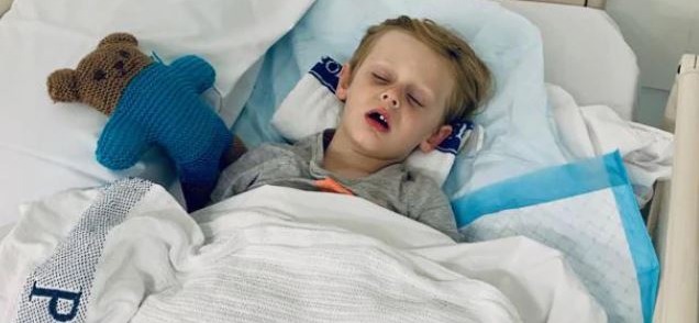Little Clifford Thompson almost died when he was attacked by a scrub python - one of the largest snakes in the world