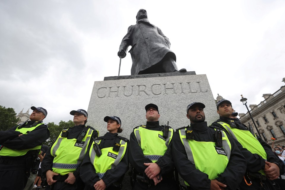 Police guarding a statue of Churchill during a BLM protest in June this year