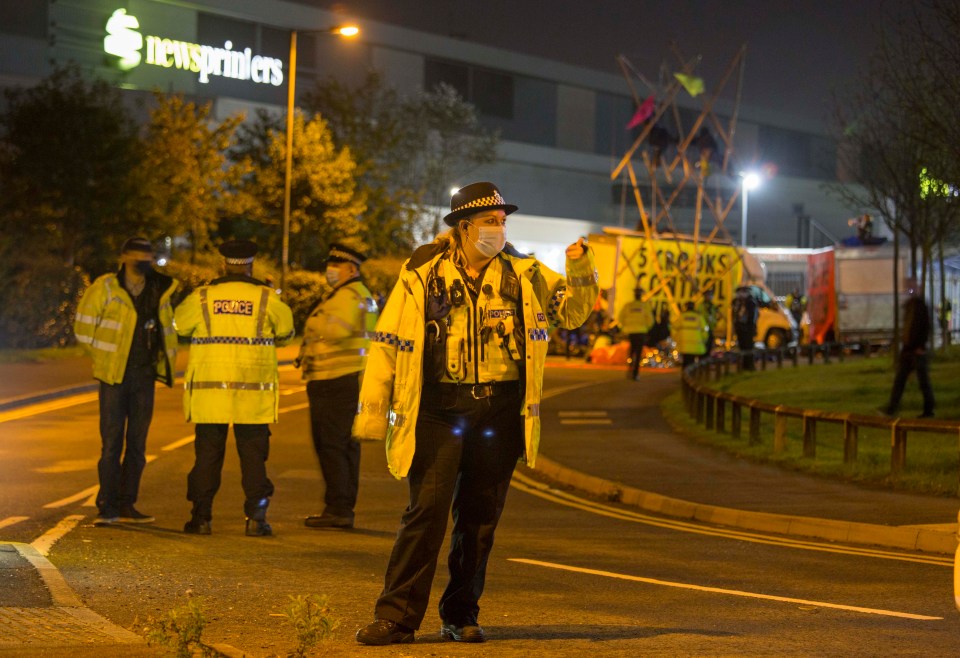 A police officer can be seen dealing with protests at Broxbourne in Hertfordshire