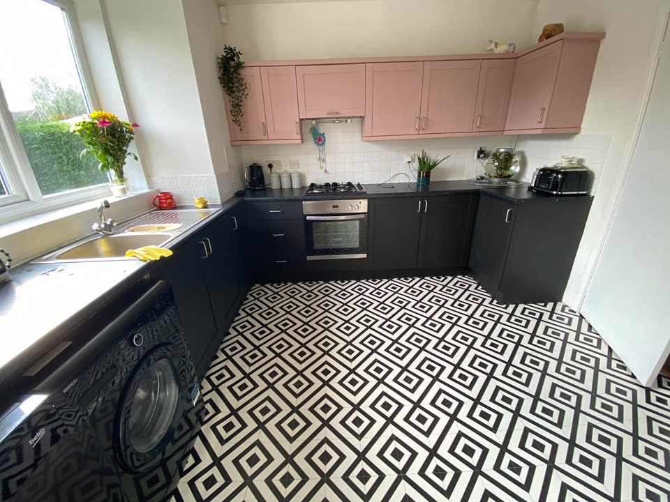 She decided to use frenchic paint and vinyl flooring to give her kitchen a stylish pink and black makeover