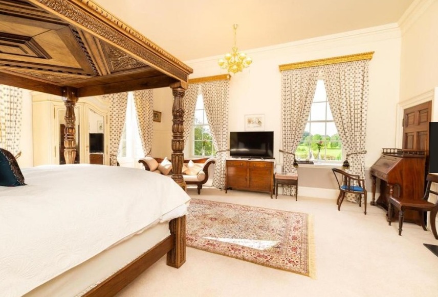One of the master bedrooms looks upon the beautiful gardens
