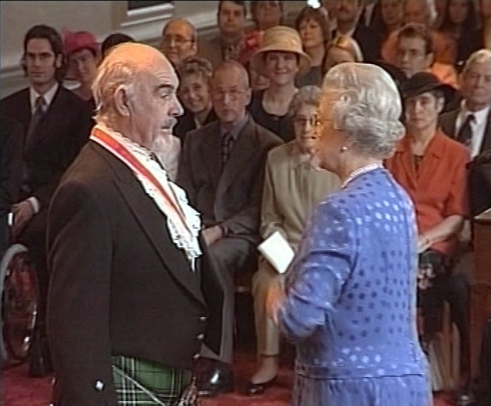 The actor being knighted by the Queen in 2000 at Holyrood Palace