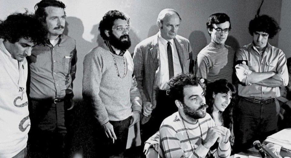 The Chicago Seven (left to right): Abbie Hoffman, John Froines, Lee Weiner, David Dellinger, Rennie Davis, and Tom Hayden, with Jerry Rubin seated