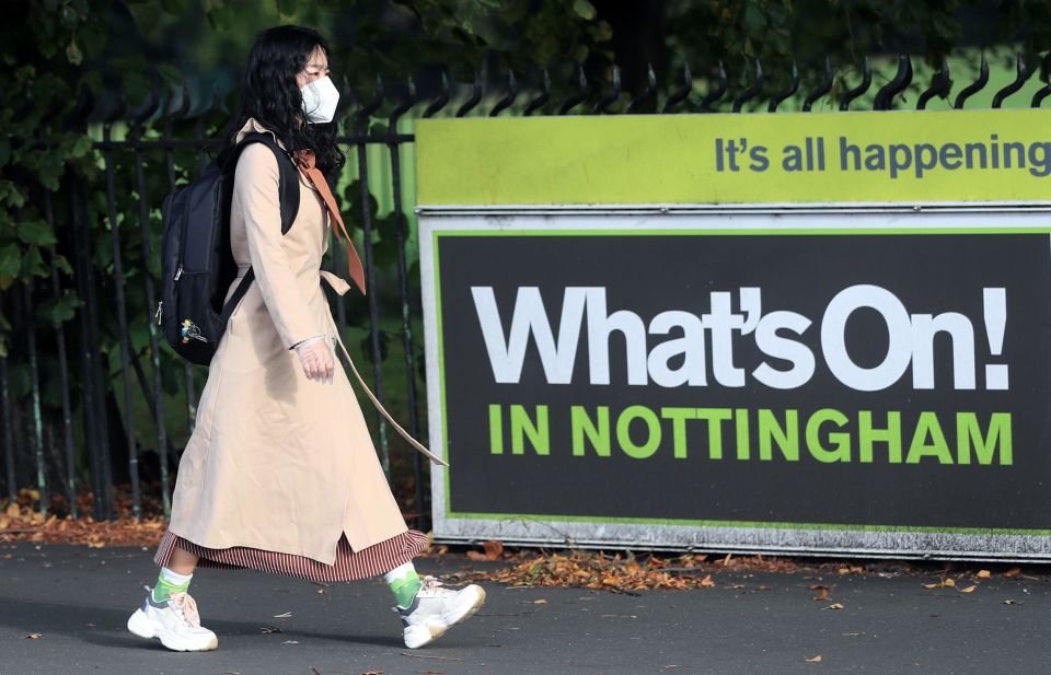 A woman wearing a mask walking through Nottingham, where infections have soared