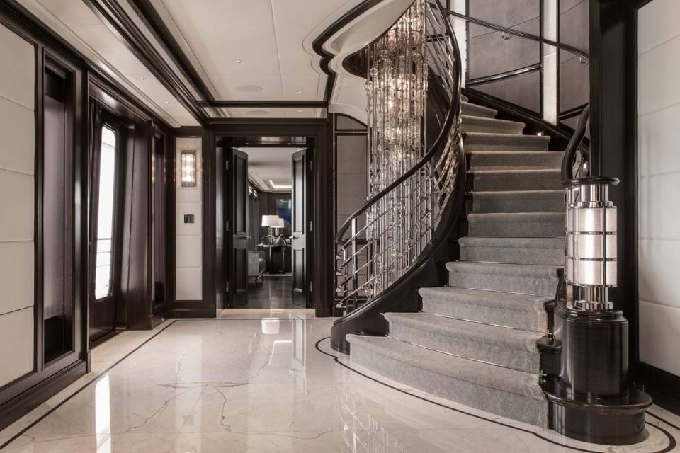 A chandelier from the top deck reaches down to the lower deck and marble floors