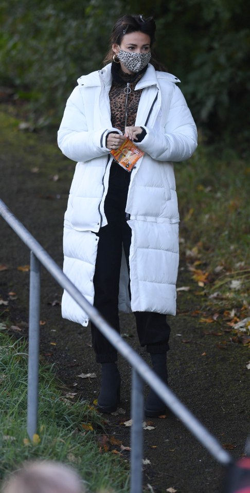 In between takes she wore a white puffer coat and opened some hand warmers