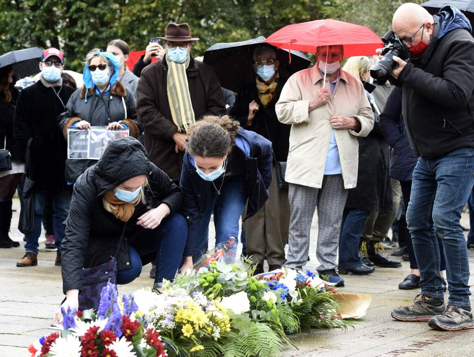 People lay flowers at the Place de la Liberte in Lille