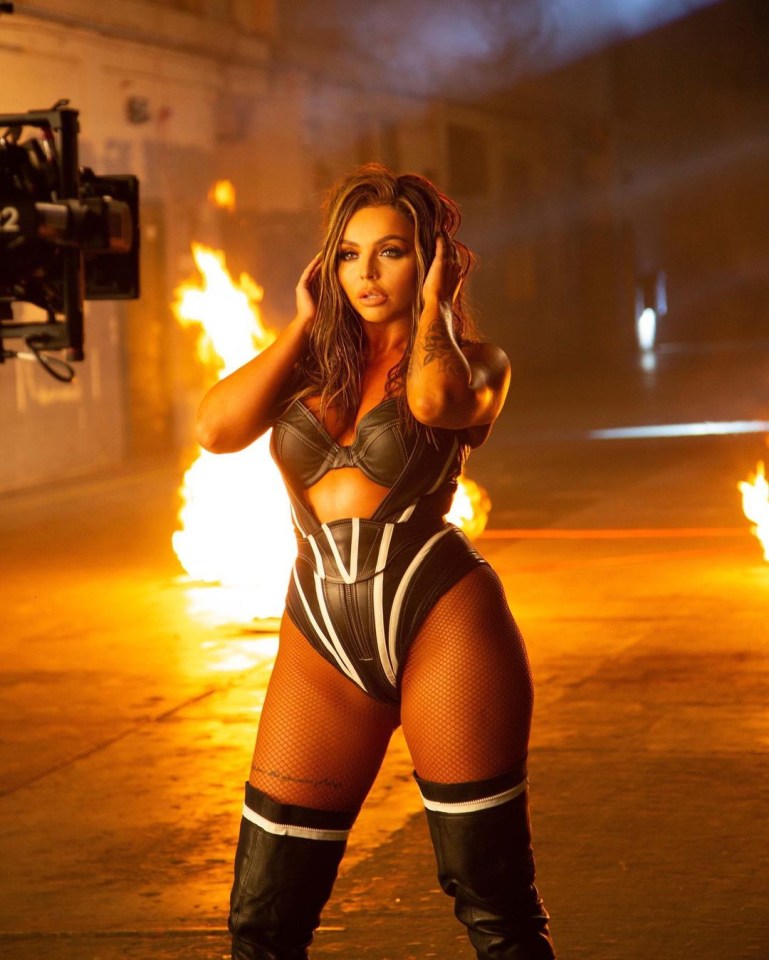 Jesy Nelson poses in a typically sexy outfit in the glossy new video