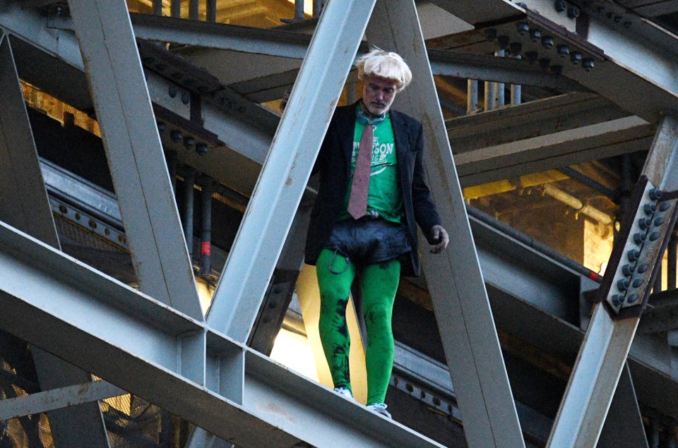 The climate change protester clung on to the tower’s scaffolding for three hours