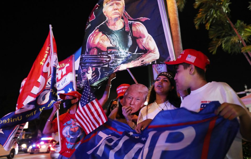  Trump supporters cheer for him outside of the Versailles restaurant in Miami