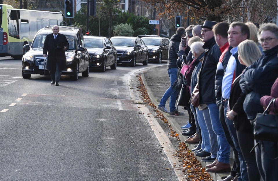 Mourners line the streets as Bobby's funeral procession arrives at the church