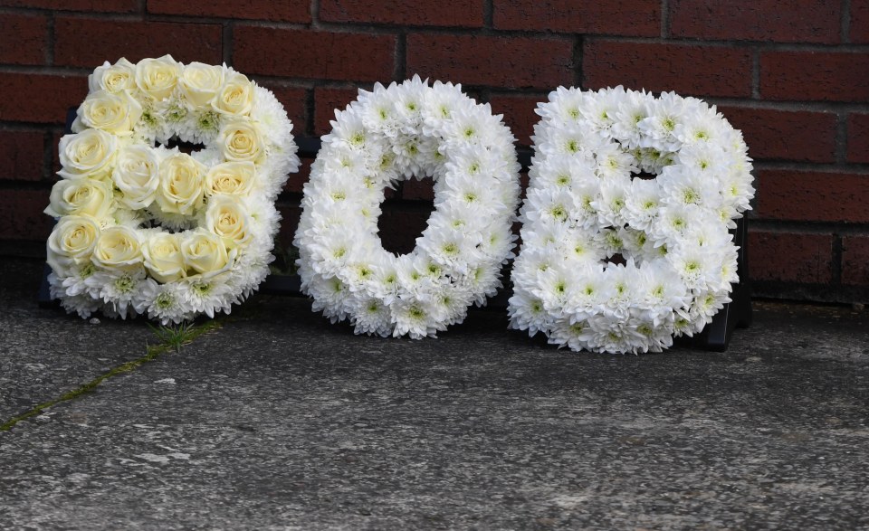 A floral tribute spells out Bob at the comedy star's funeral today