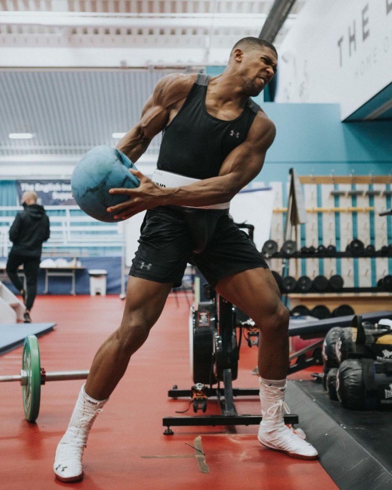 Anthony Joshua showed off his bulging biceps in the gym