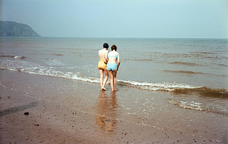 These women walk to the waters edge before taking a dip in the ocean